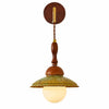 Japanese wabi sabi wall sconce with walnut wood wall plate, brass arm, green textured shade and frosted globe
