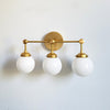 Three-Light Wall Sconce - Modern Brass & Glass Lighting for Home