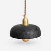 Black carved wood pendant lamp on a clean background