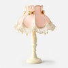 Blush pink satin lace table lamp on a light background