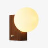 Luma folded globe wall sconce in Walnut