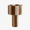 Coffee and white striped woven shade table lamp on a white background