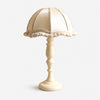 Cream fabric shade wood table lamp on white background