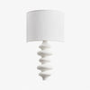 White sculptural wall lamp with white fabric shade
