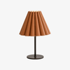 Caramel brown pleated leather table lamp with dark metal base