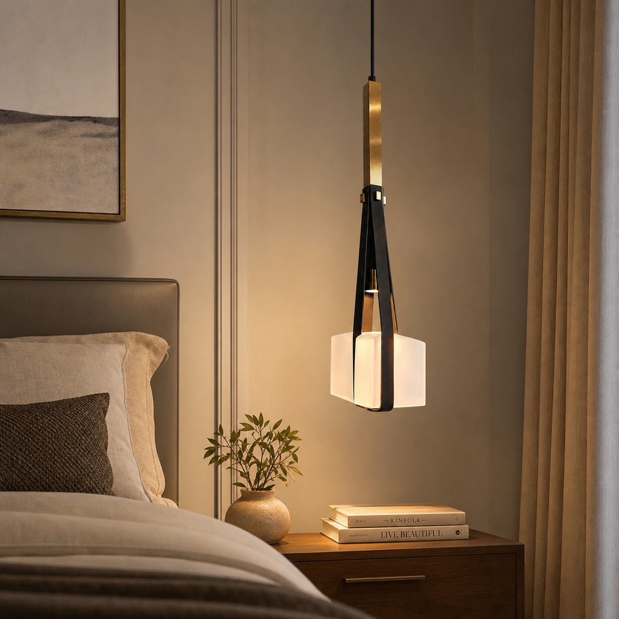 Black leather and white glass pendant lamp beside a bed