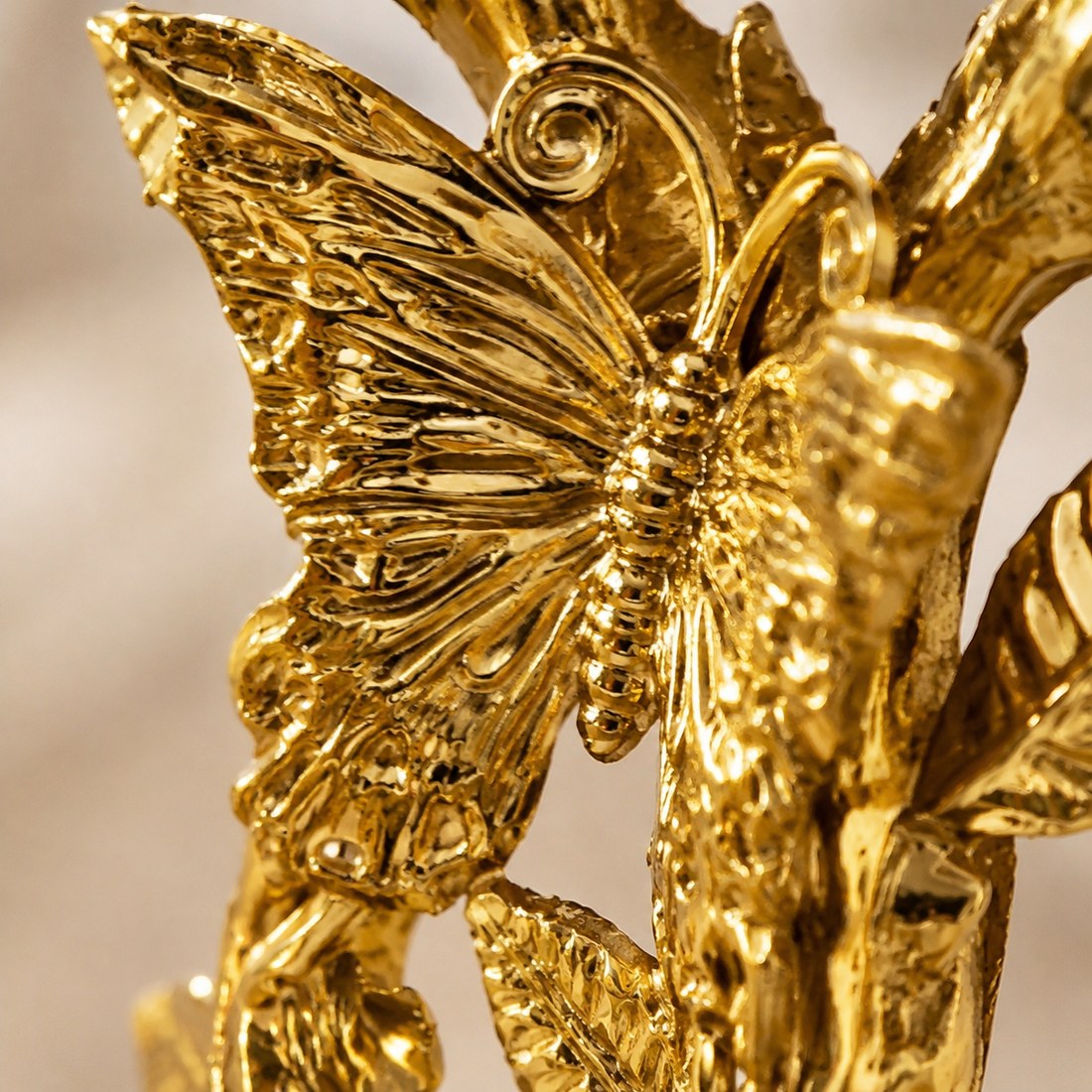 Macro detail of the butterfly wing texture on the gold candlestick
