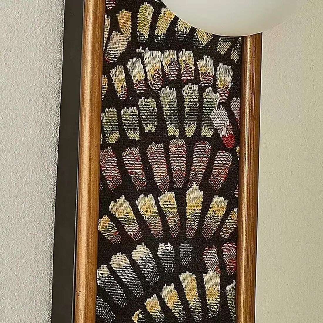 Close detail of fabric panel and warm metal edge