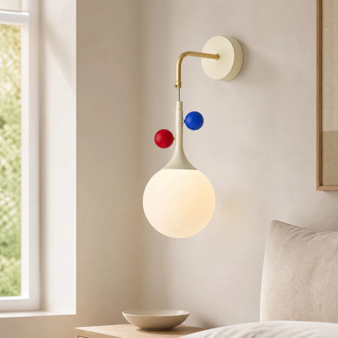 Cream orbit-disc globe wall sconce near a window