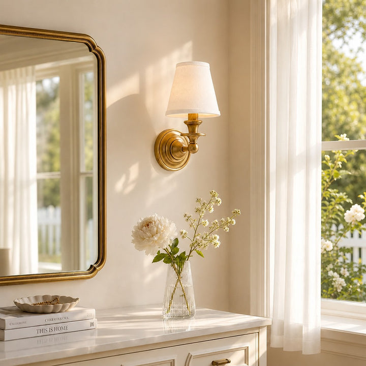 Kalvora White Pleated Brass wall sconce beside a bathroom mirror