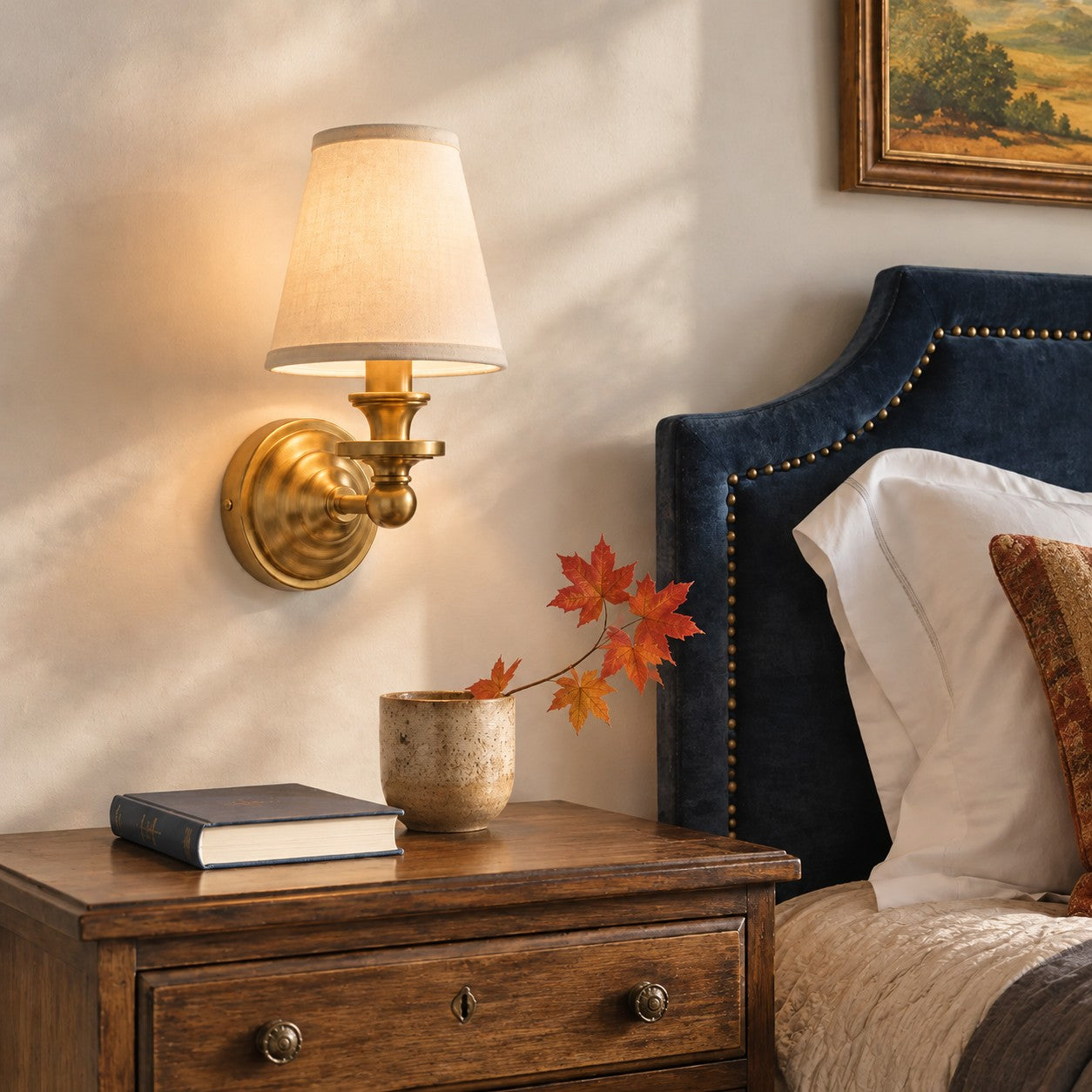 Kalvora wall sconce beside a bedroom headboard