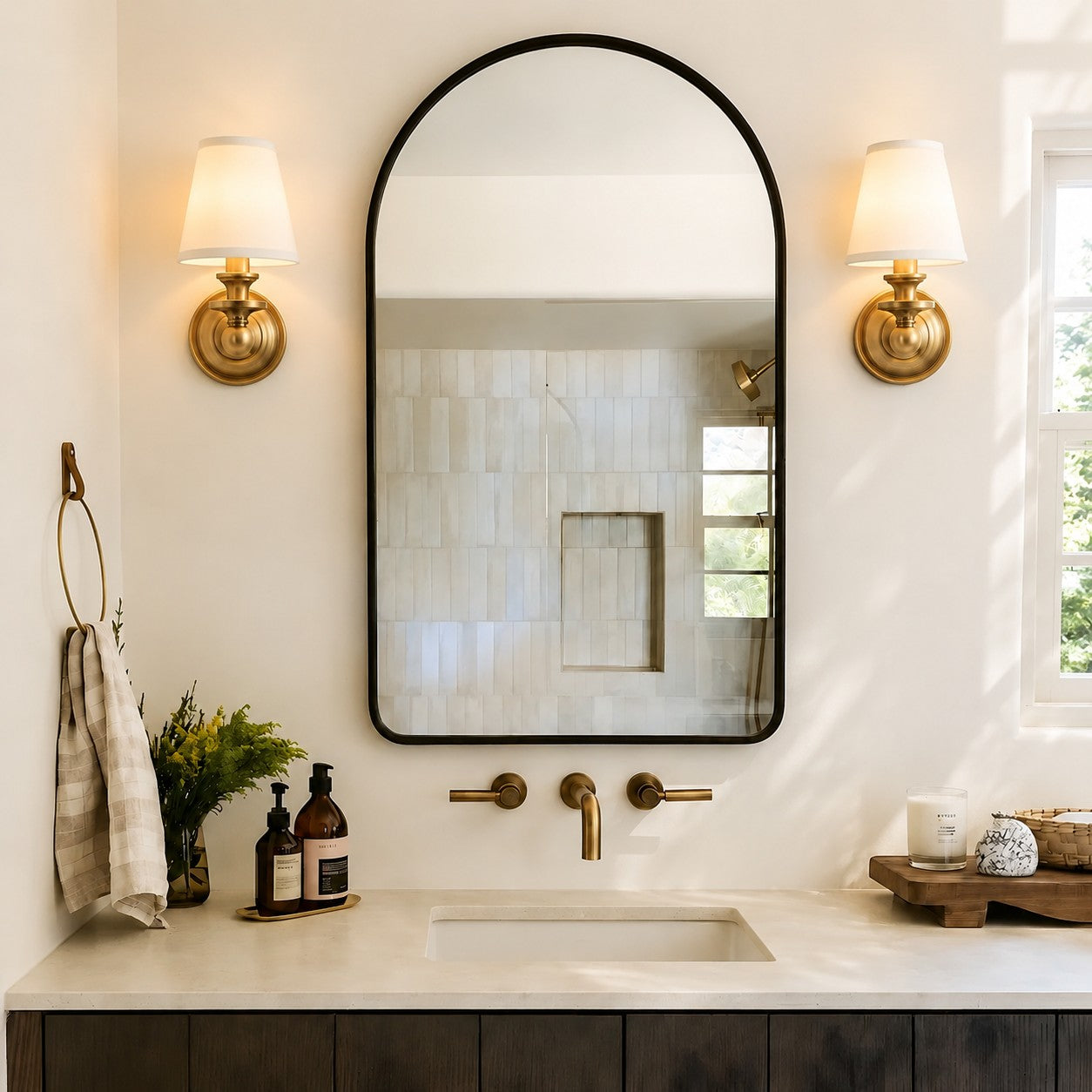 Pair of Kalvora wall sconces beside a bathroom mirror