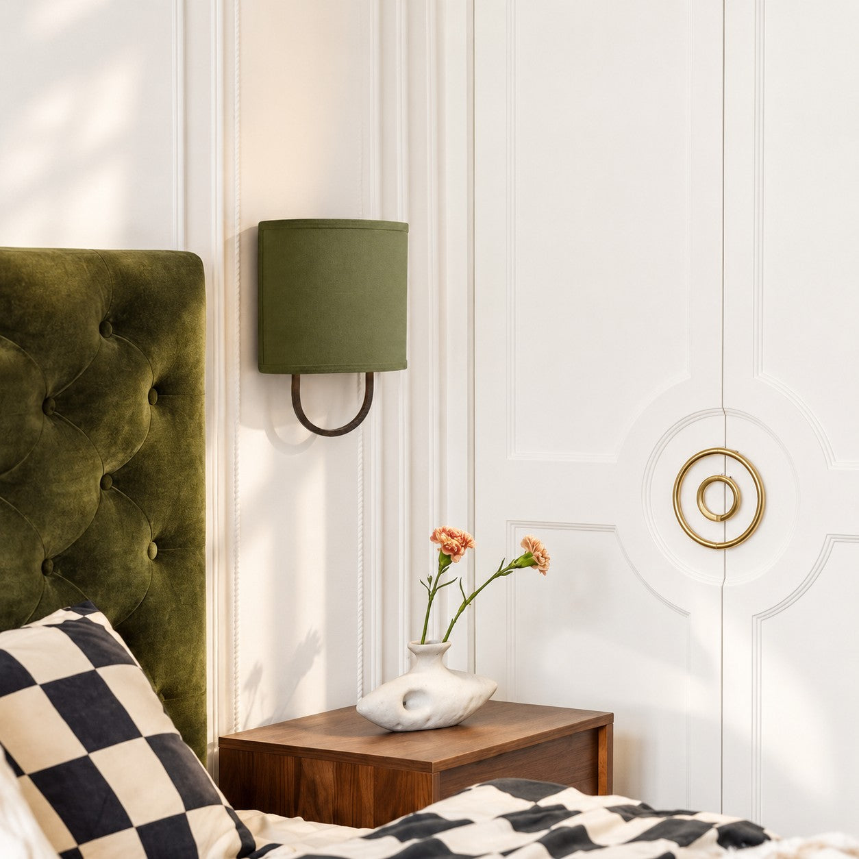 Nolvara Green Bronze wall light beside a bedroom headboard
