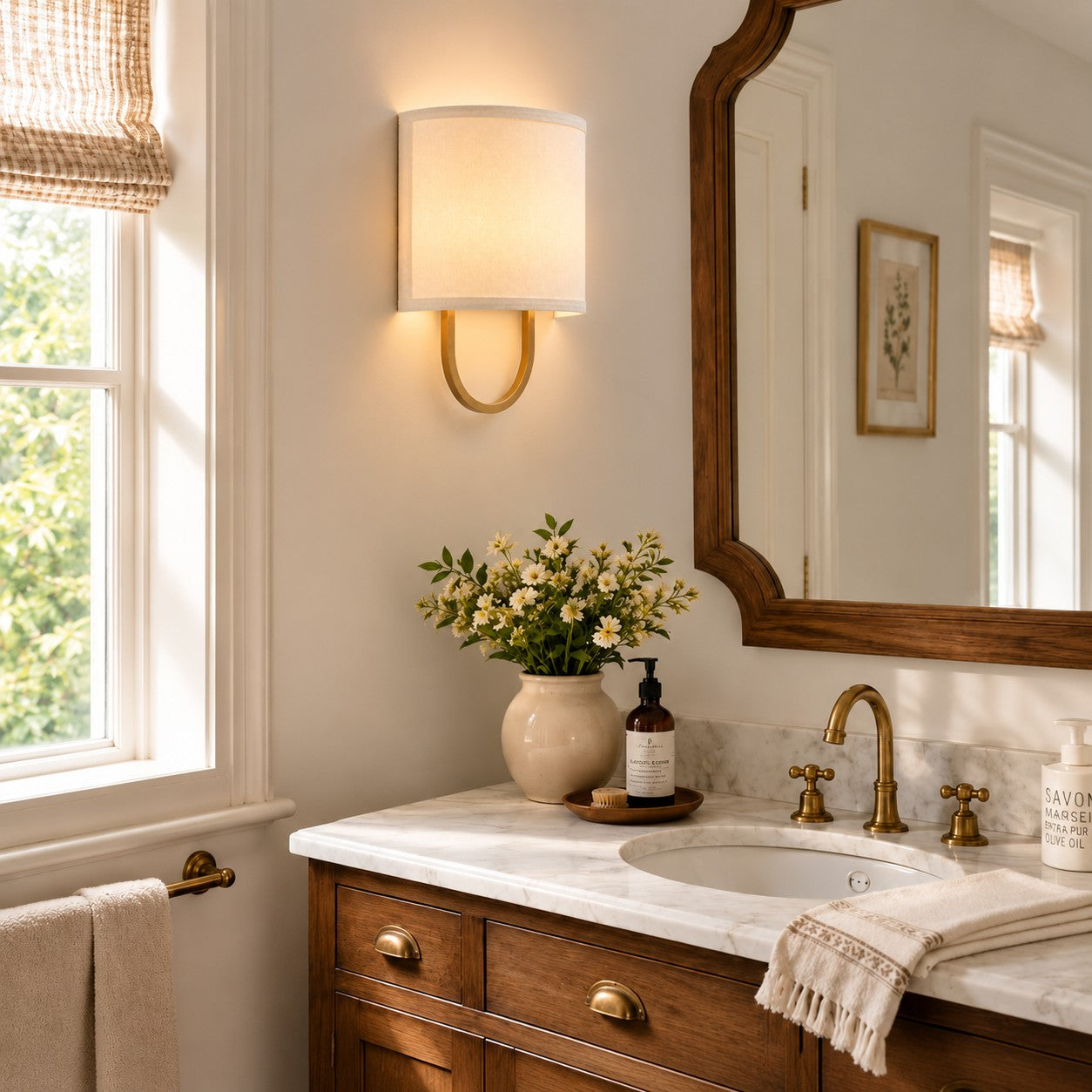 Nolvara White Antique Brass wall light beside a bathroom mirror