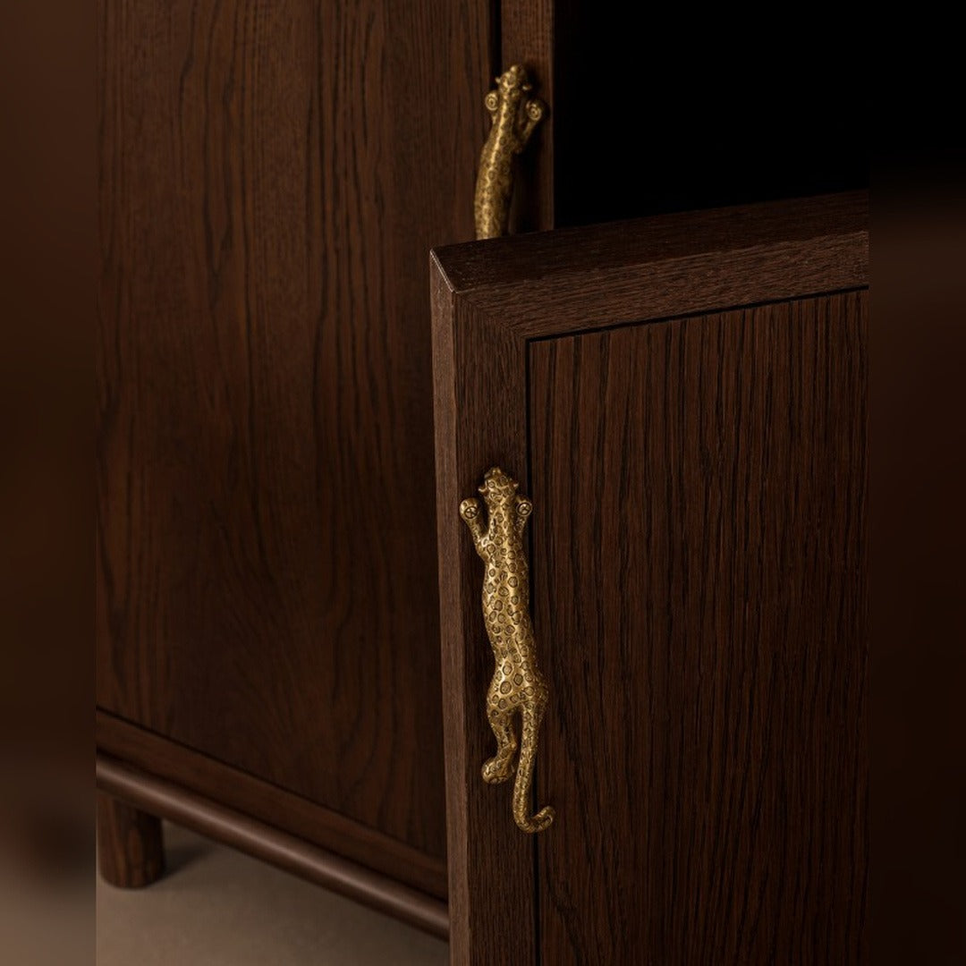 Leopard B brass cabinet handle on a cabinet door