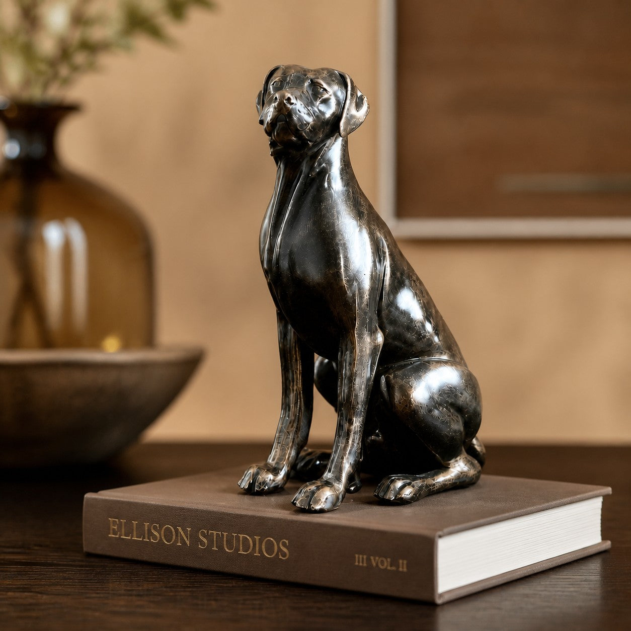 Floxo sitting dog sculpture displayed on books