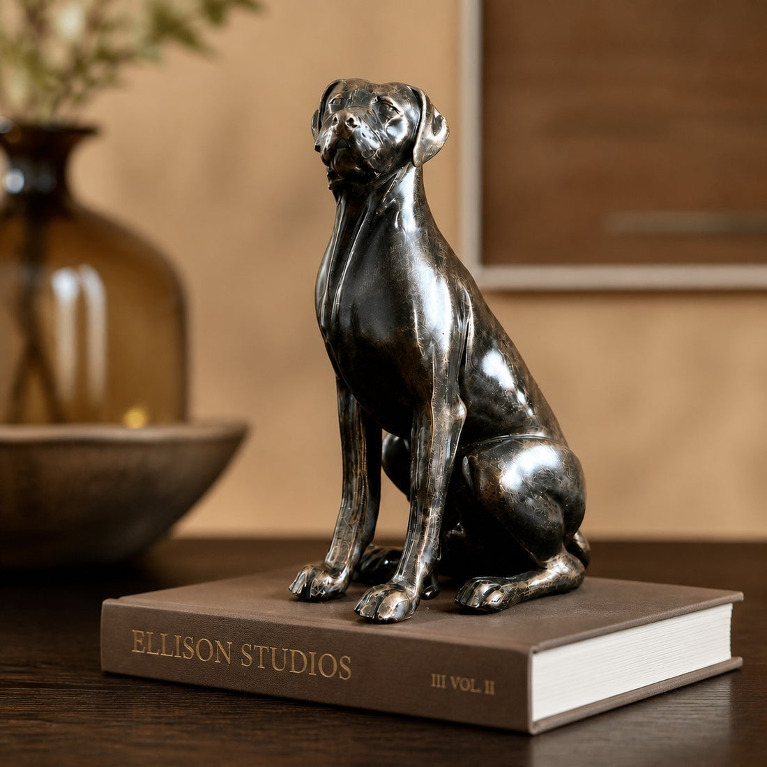 Floxo sitting dog sculpture displayed on books