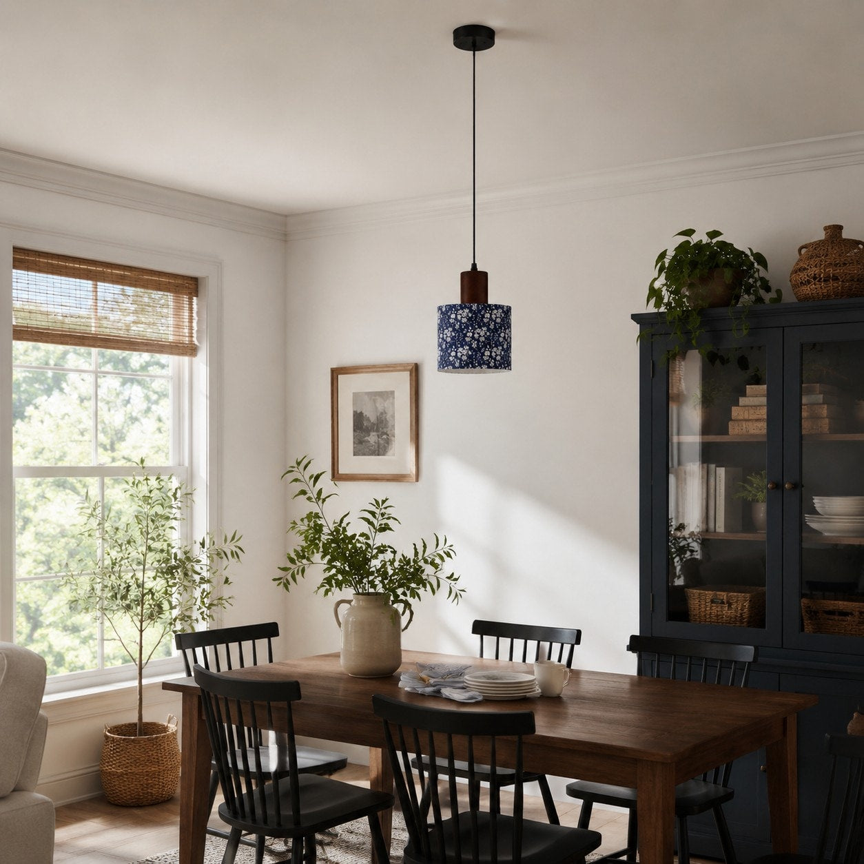Blue floral fabric drum pendant light above a dining table