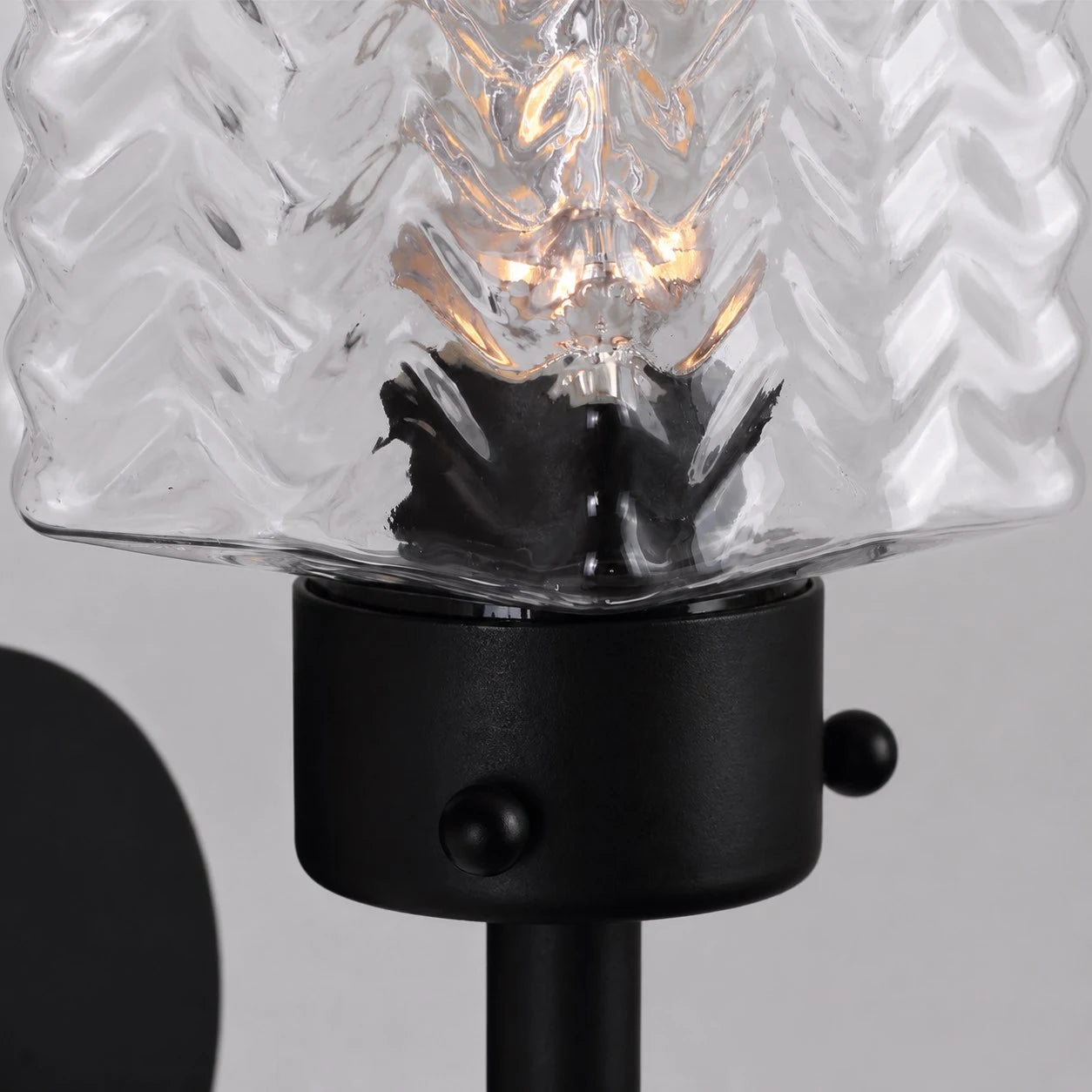 Close view of rippled glass shade with warm bulb