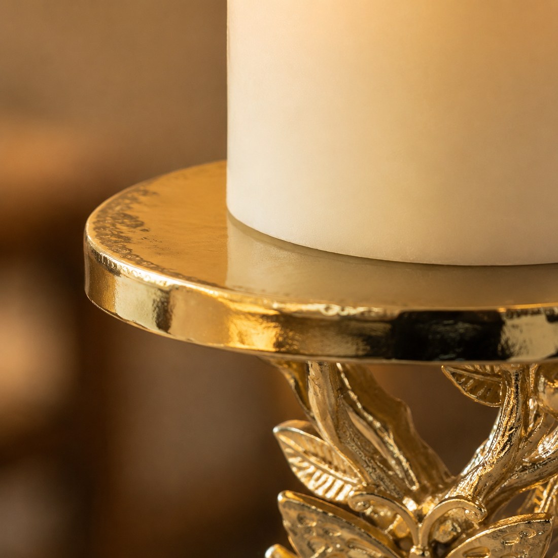 Close detail of a candle resting on the gold top plate