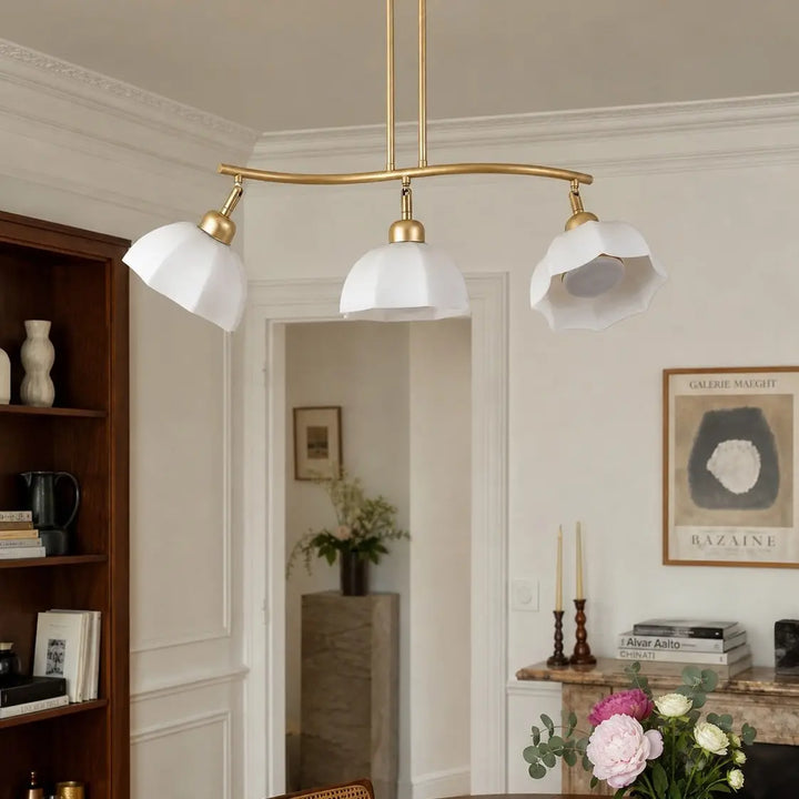 Three-light chandelier installed above a dining area