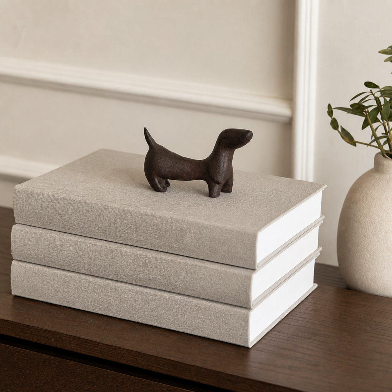 Cast iron Dachshund figurine displayed with books