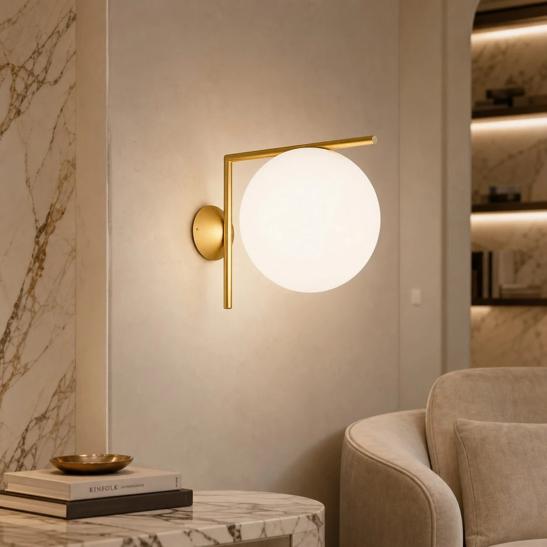 Gold offset globe wall sconce in a reading corner
