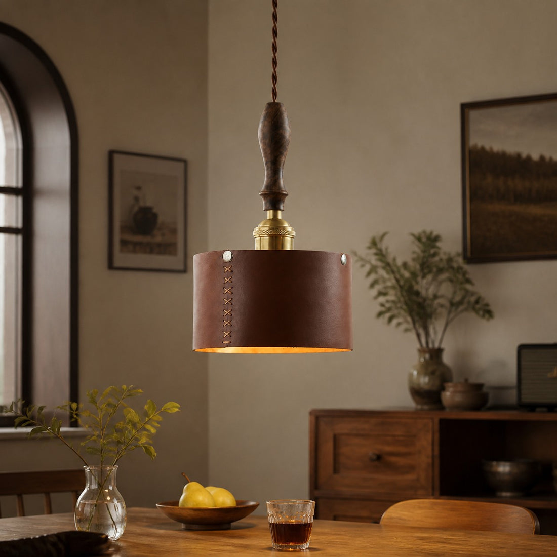 Leather pendant lamp above a dining table