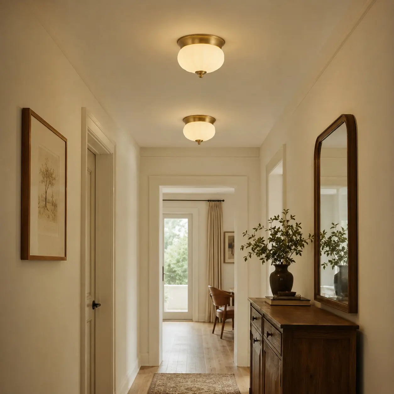 Two brass and opal glass ceiling lights in a hallway