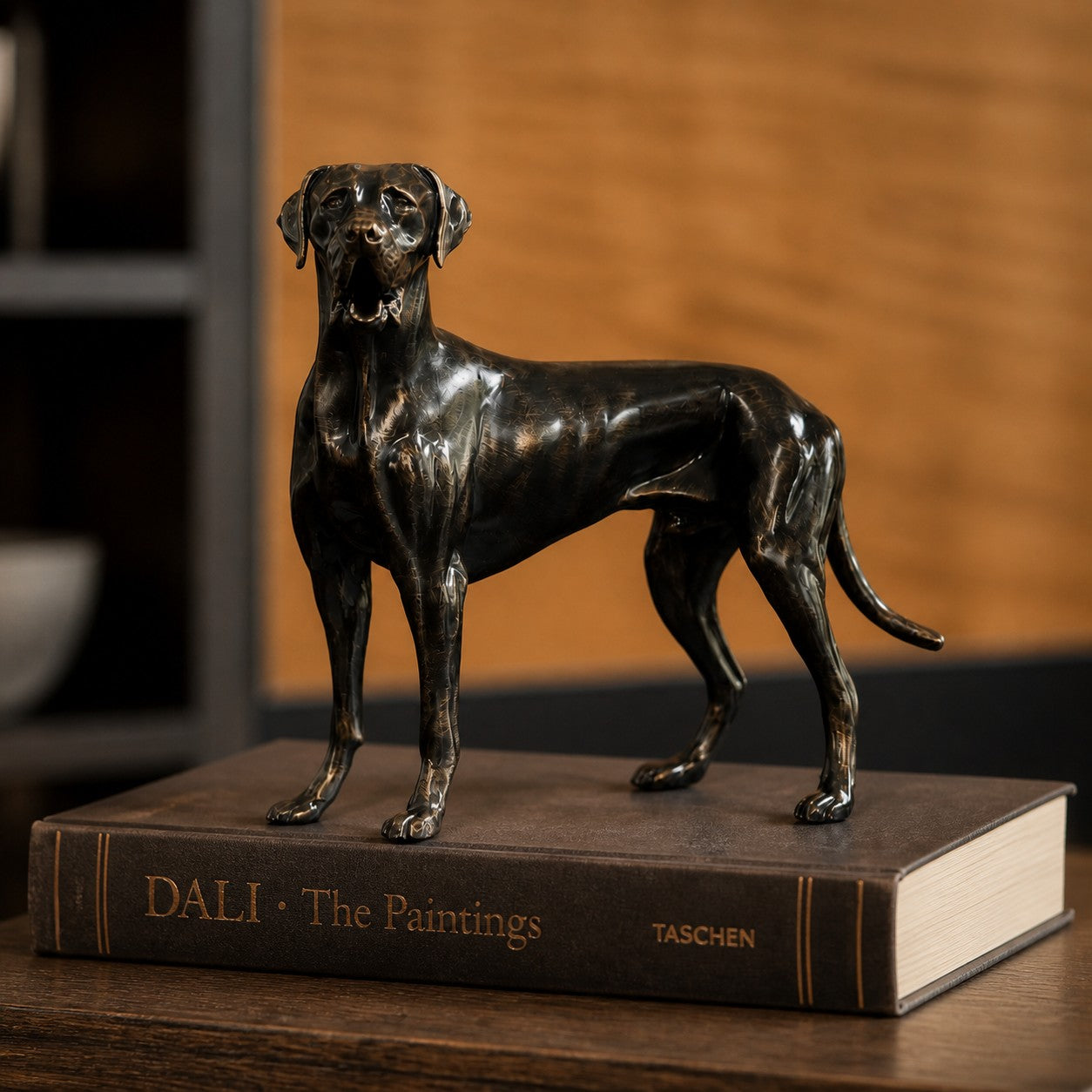 Floxo standing dog sculpture displayed on books