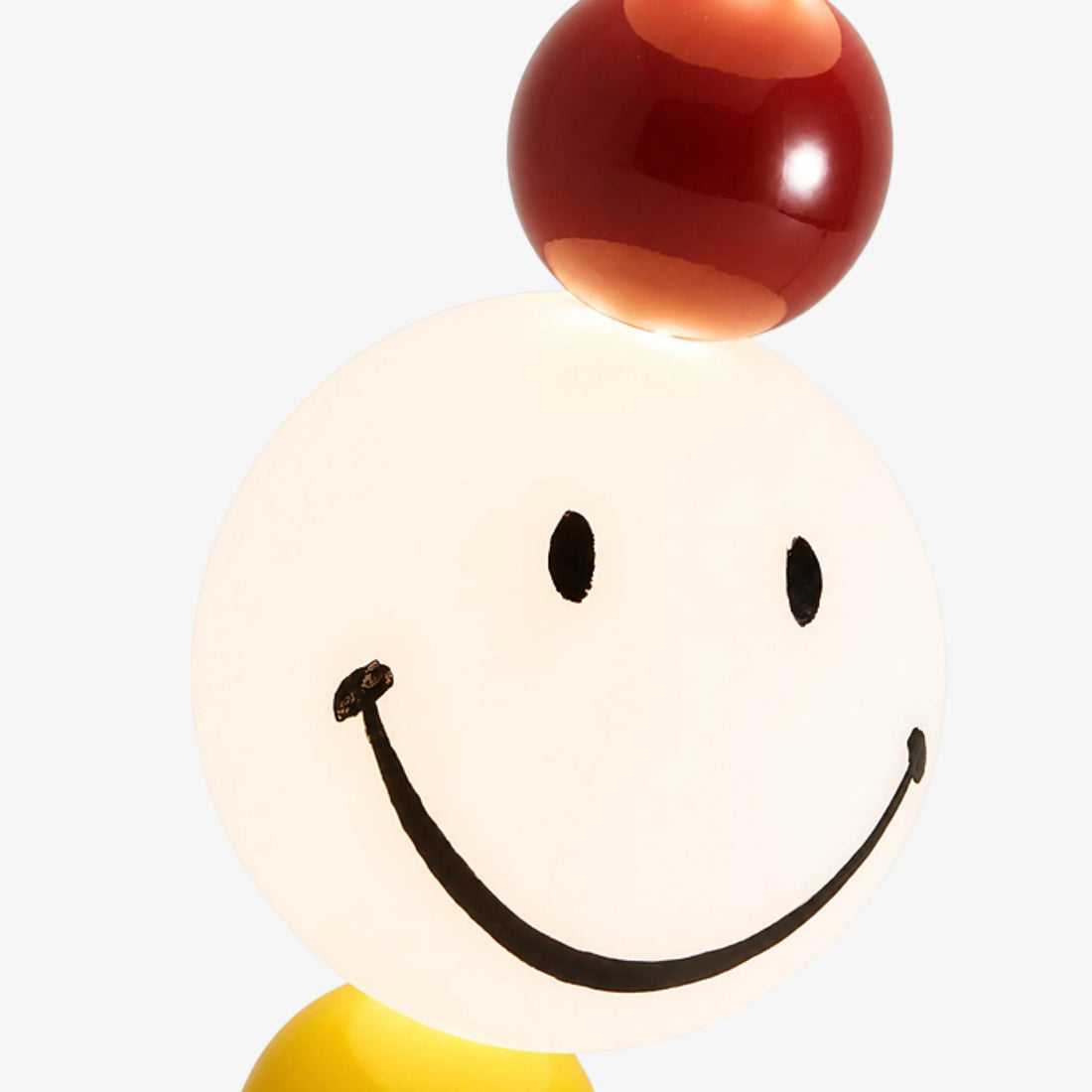 Illuminated smiley globe and red accent sphere detail