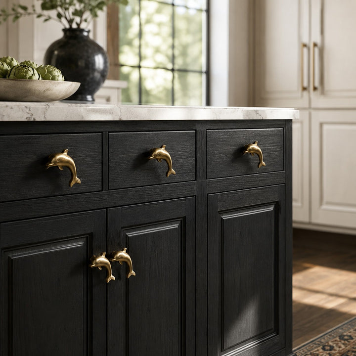 Totem dolphin cabinet handles installed on black kitchen cabinetry