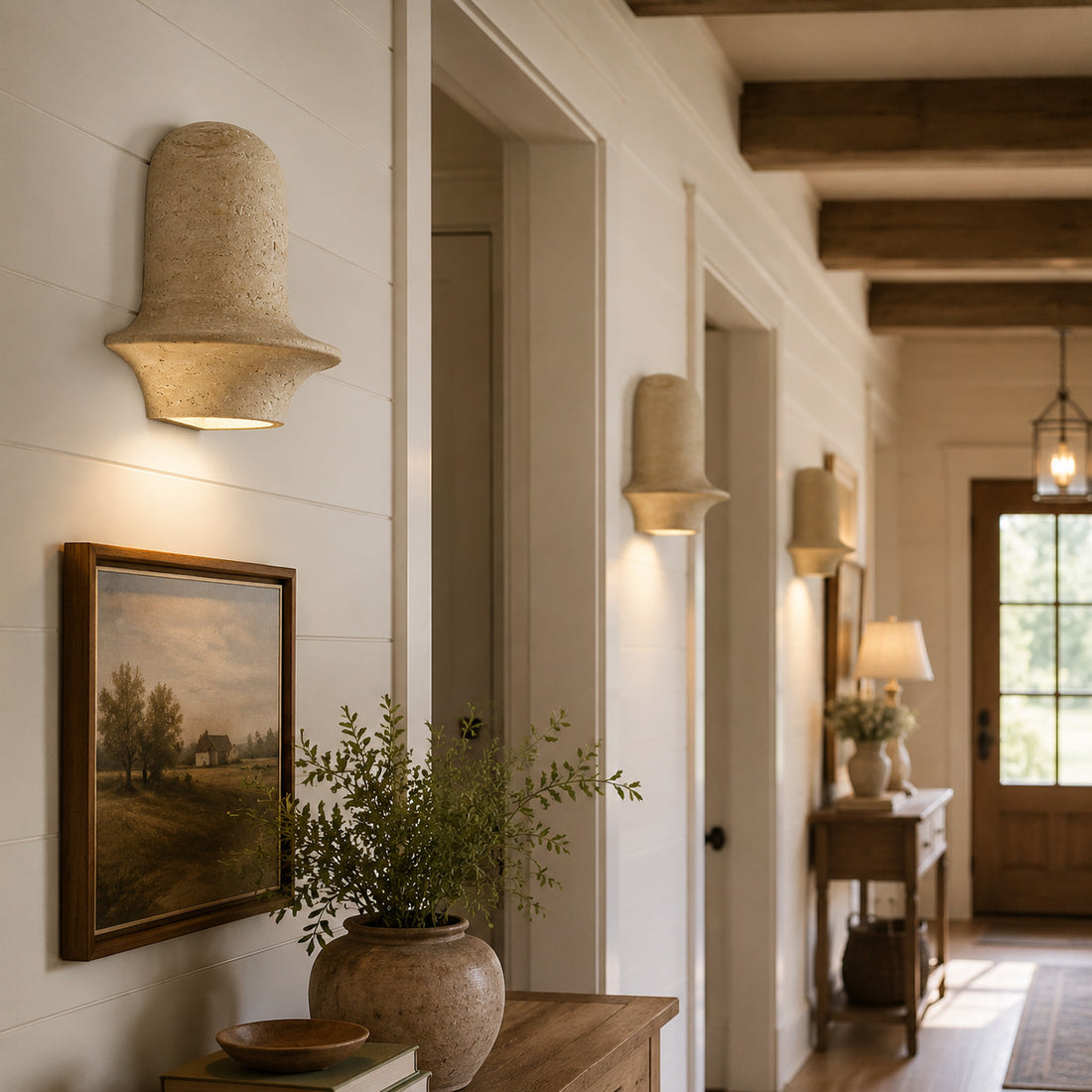 Travertine wall sconces installed along a warm hallway with wood beams