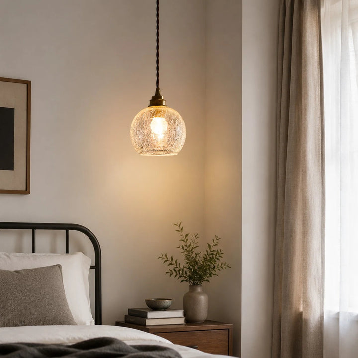 brass glass pendant light used as warm bedside lighting