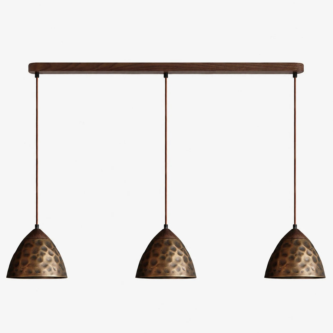 Three-light hammered copper hill pendant on walnut ceiling base