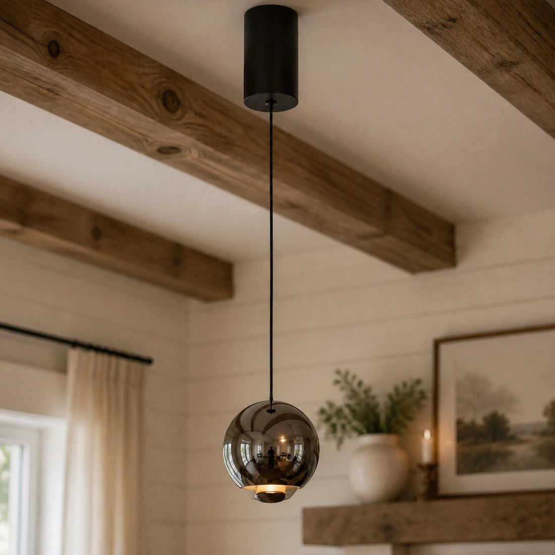 Pearl Black mirrored orb pendant in a warm rustic interior