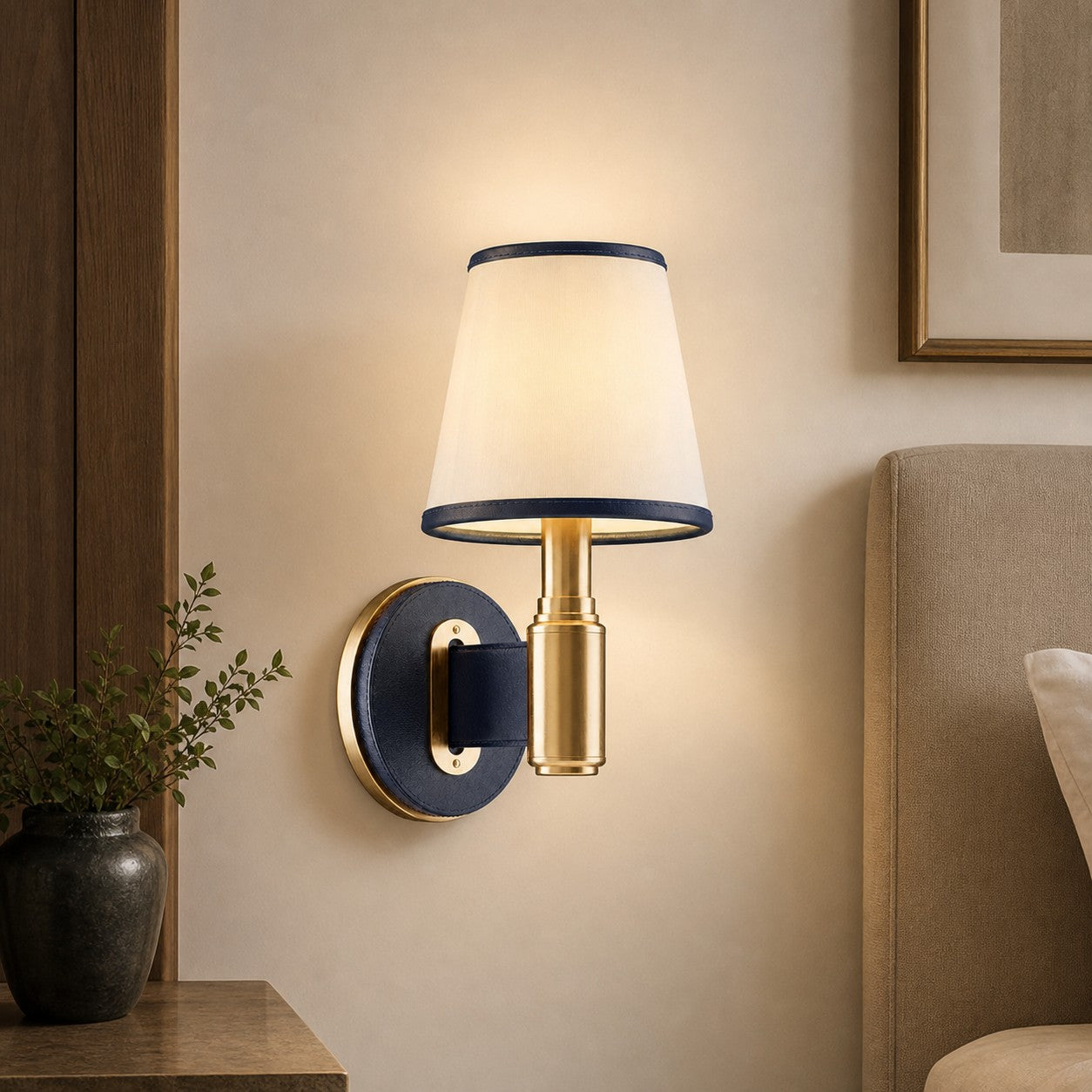 Navy leather wall lamp beside an upholstered bed