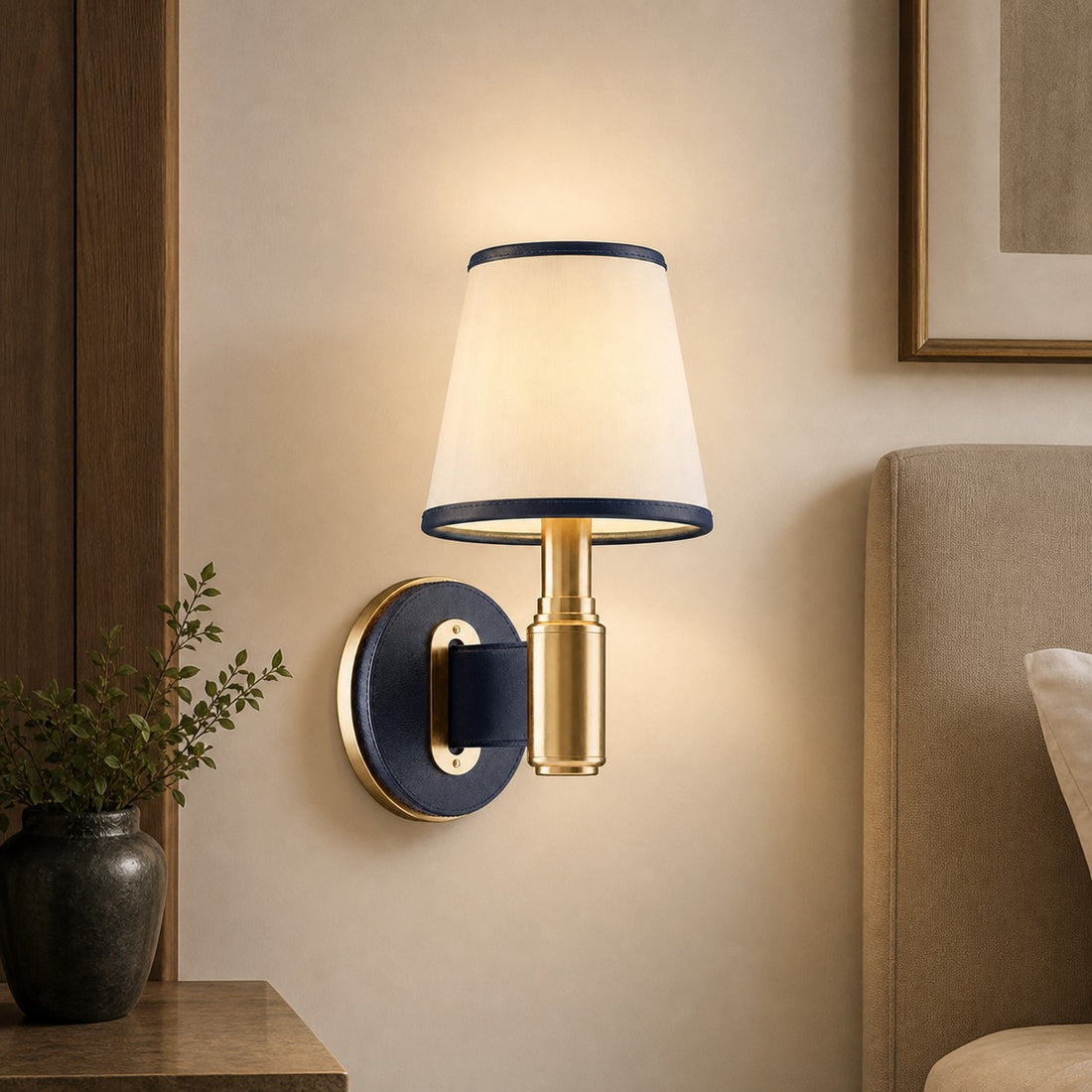 Navy leather wall lamp beside an upholstered bed