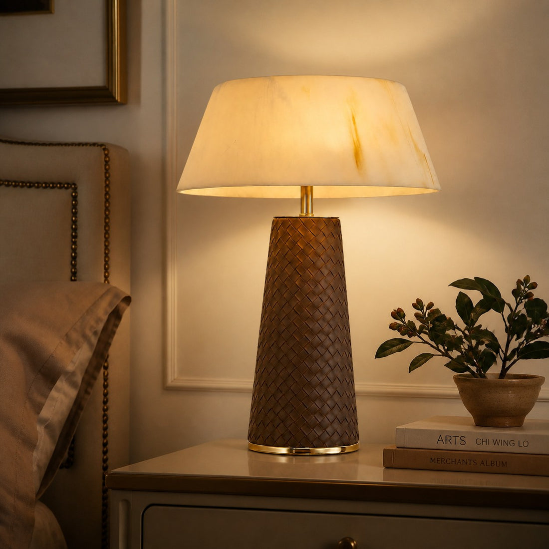 Leather table lamp styled beside an upholstered bed