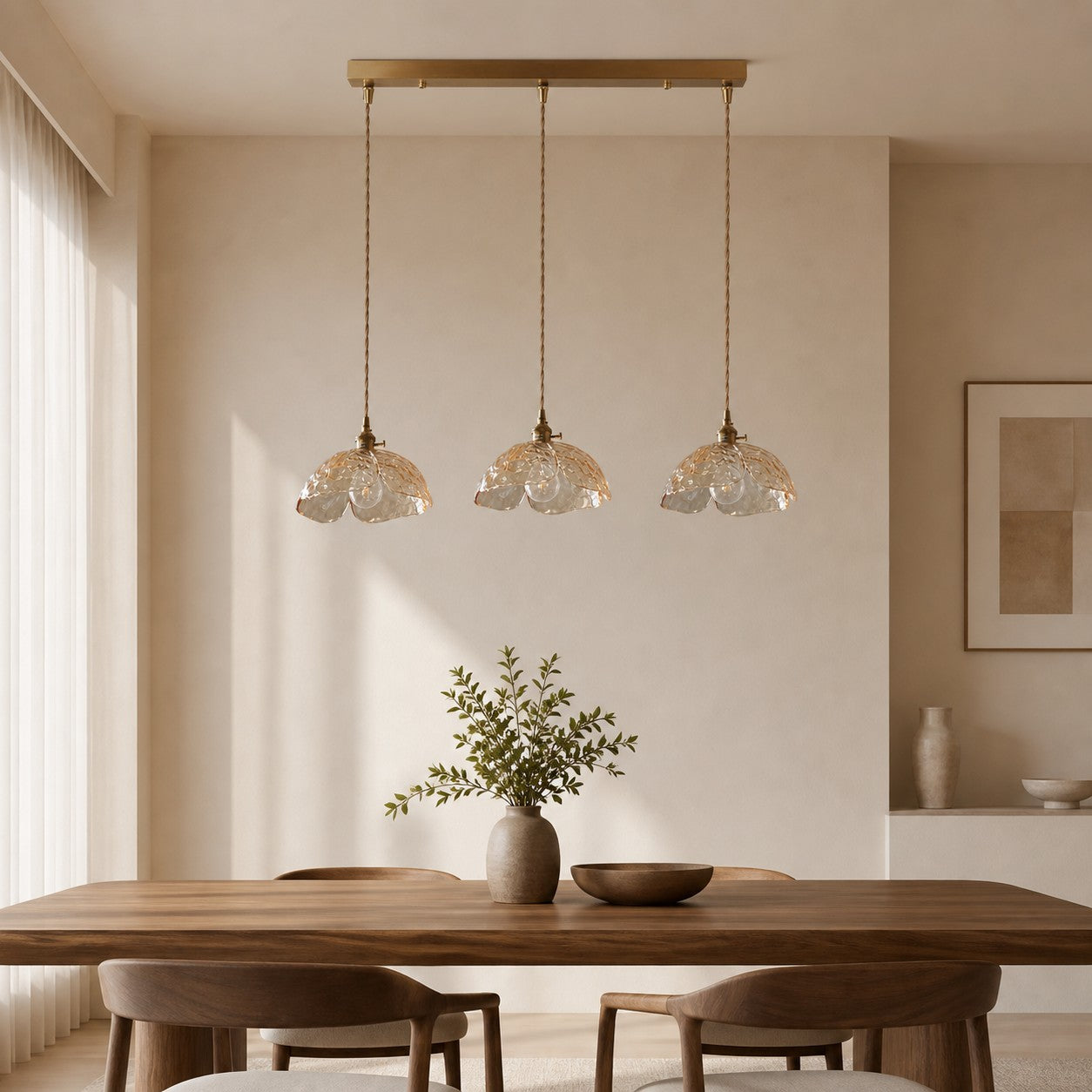 Three clear flower pendants over a wood dining table