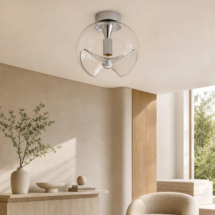 Chrome and Clear ceiling light in a minimal interior