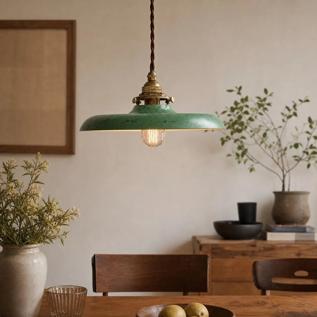 Distressed green pendant light in a dining room