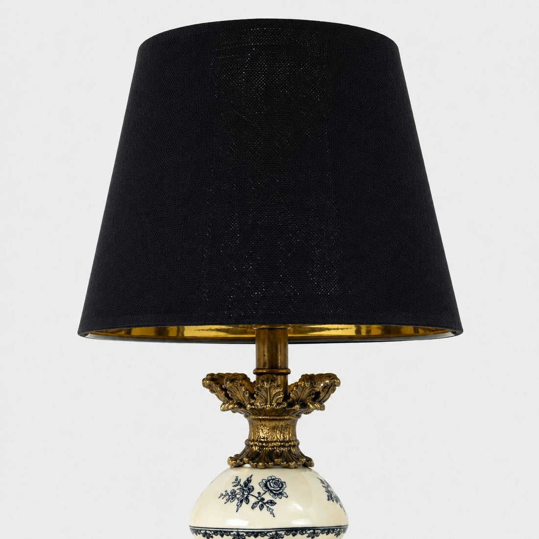Black fabric shade and brass tone inner rim detail