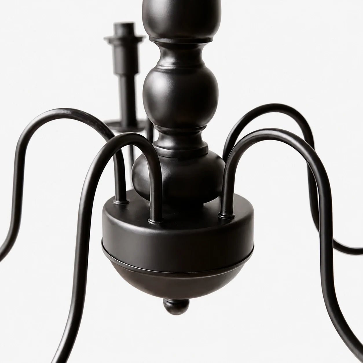 Close view of the black curved chandelier arms and central body
