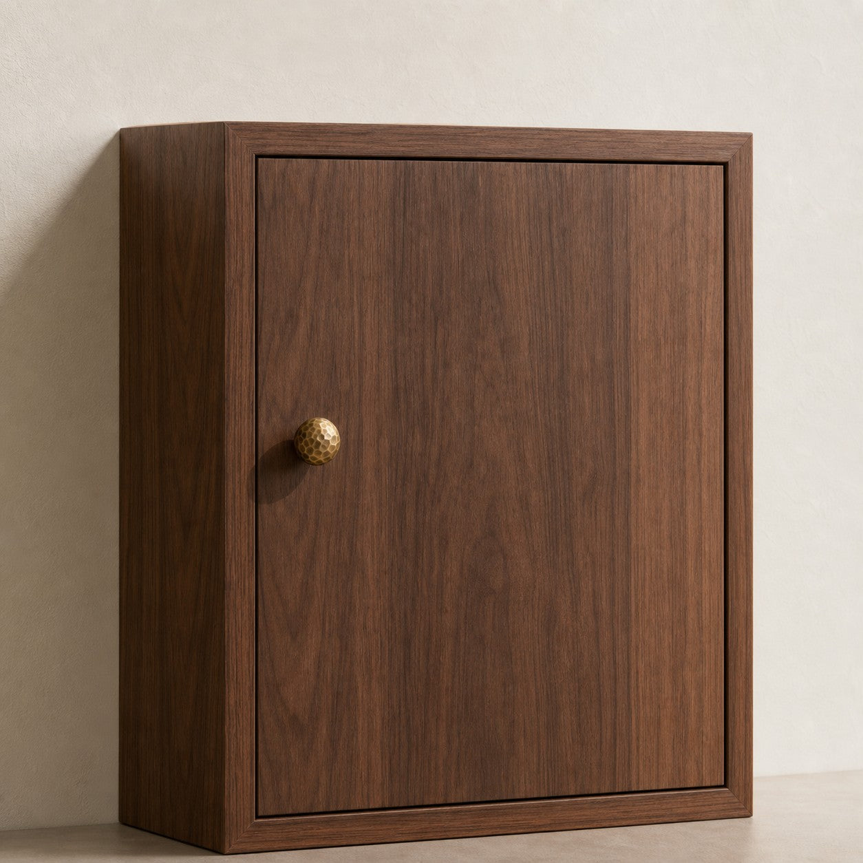 Small antique brass knob on a cabinet door