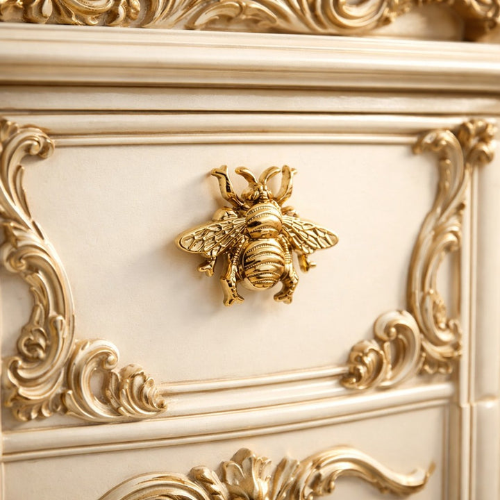 Gold Totem bee handle on ornate cabinet front