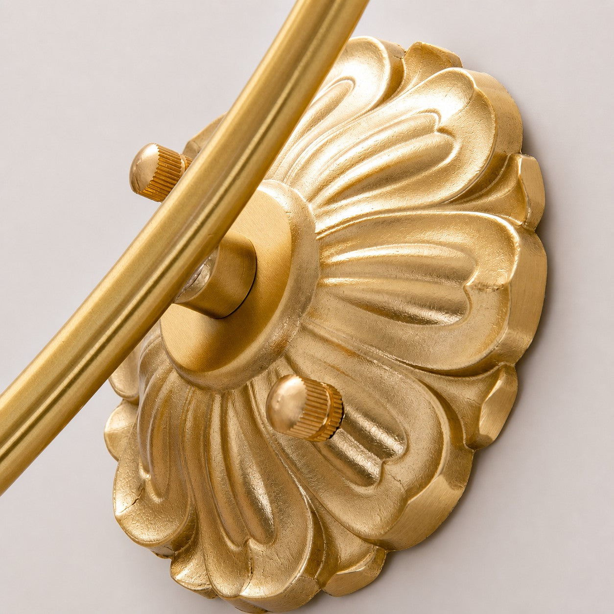 Close-up of sculpted wall plate and arm connection
