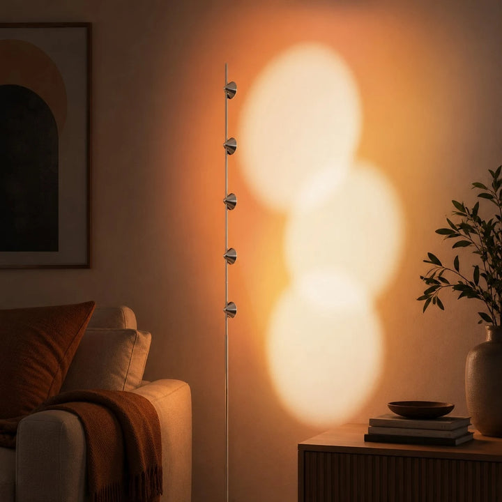 Sunset projection floor lamp glowing beside a lounge chair