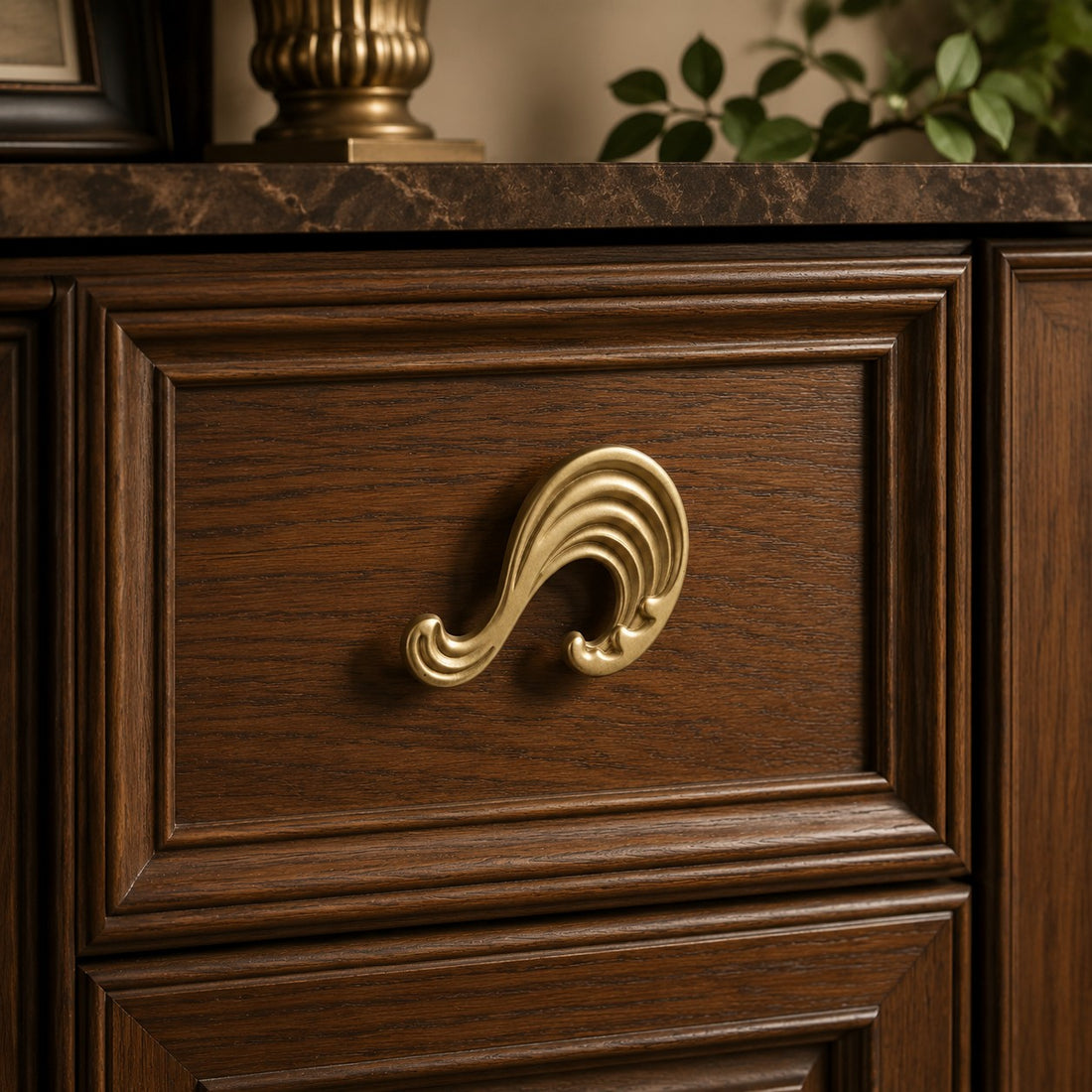 Natural brass wave handle on a wood cabinet front