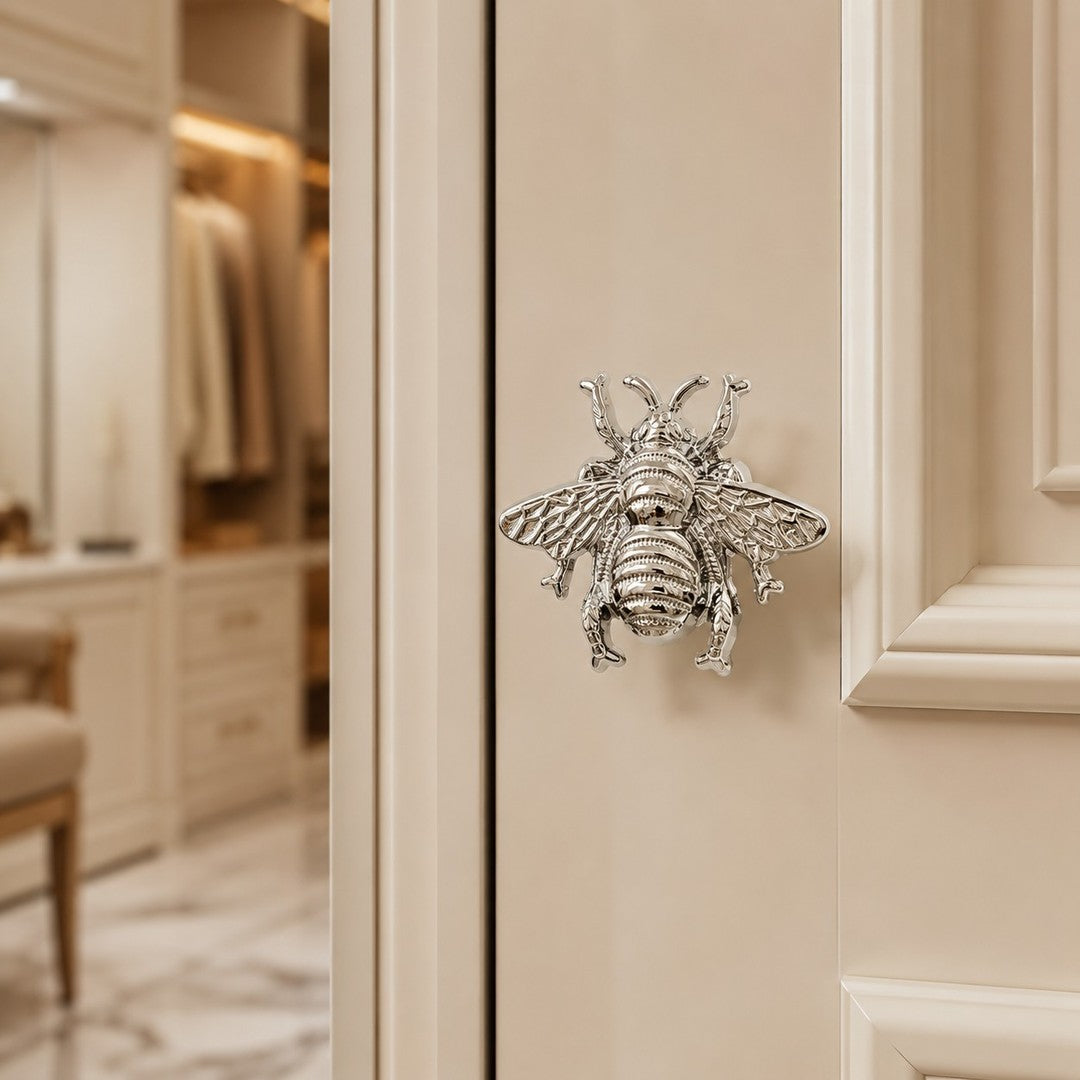 Chrome Totem bee handle on pale cabinet door